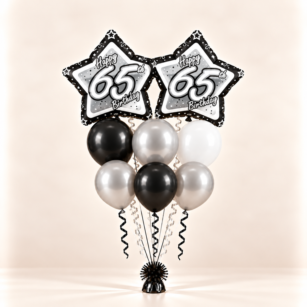 65th birthday bouquet with two star foil balloons and six black silver and white balloons