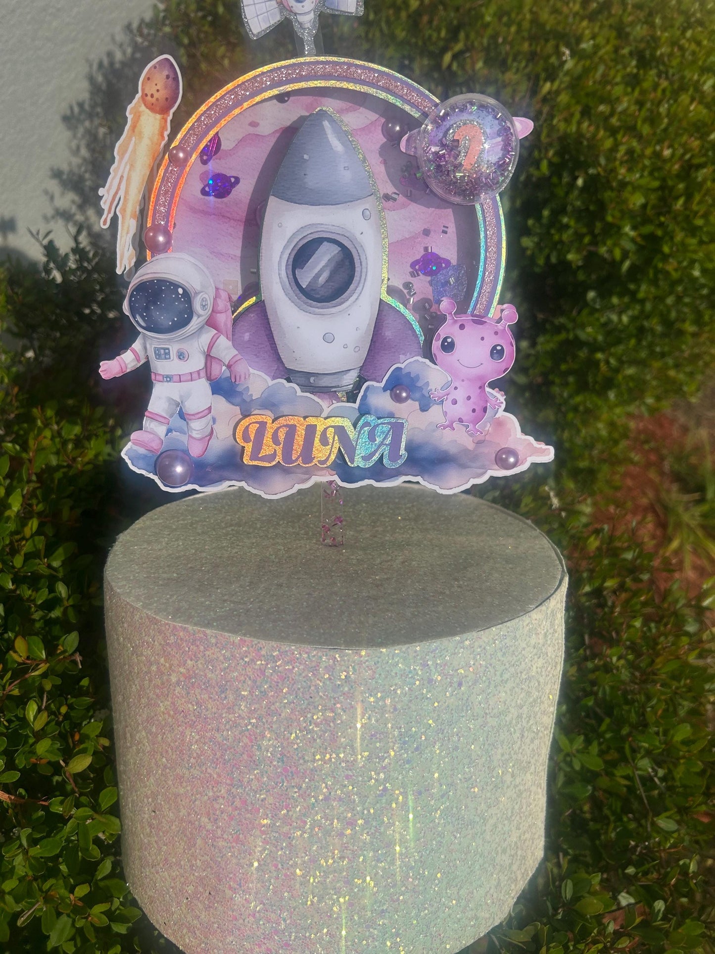 Astronaut-themed birthday cake topper for a "Over the Moon" first trip around the sun first birthday party.