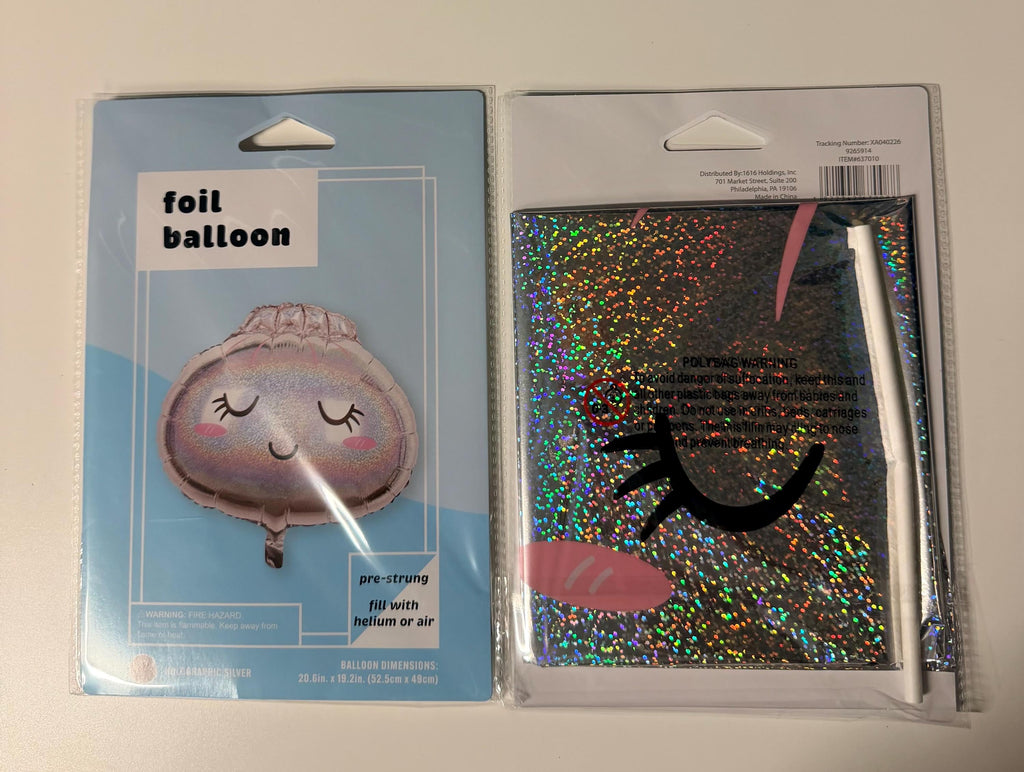 Holographic silver smiling dumpling foil balloon in retail packaging