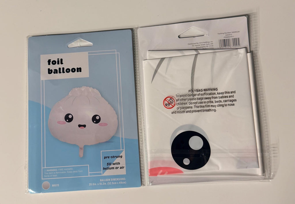 White smiling dumpling foil balloon in retail packaging