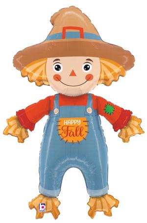 Smiling scarecrow foil balloon wearing blue overalls