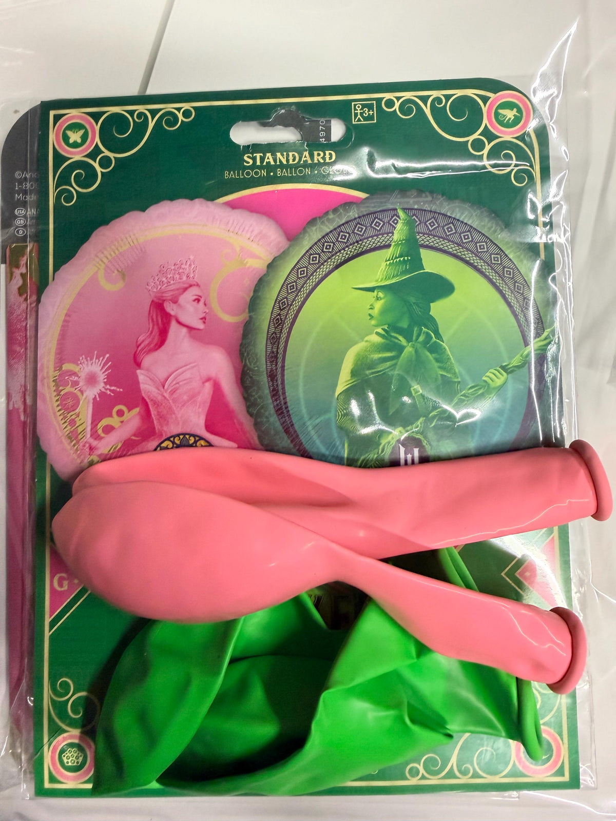 Packaged Wicked foil balloon with pink and green balloons