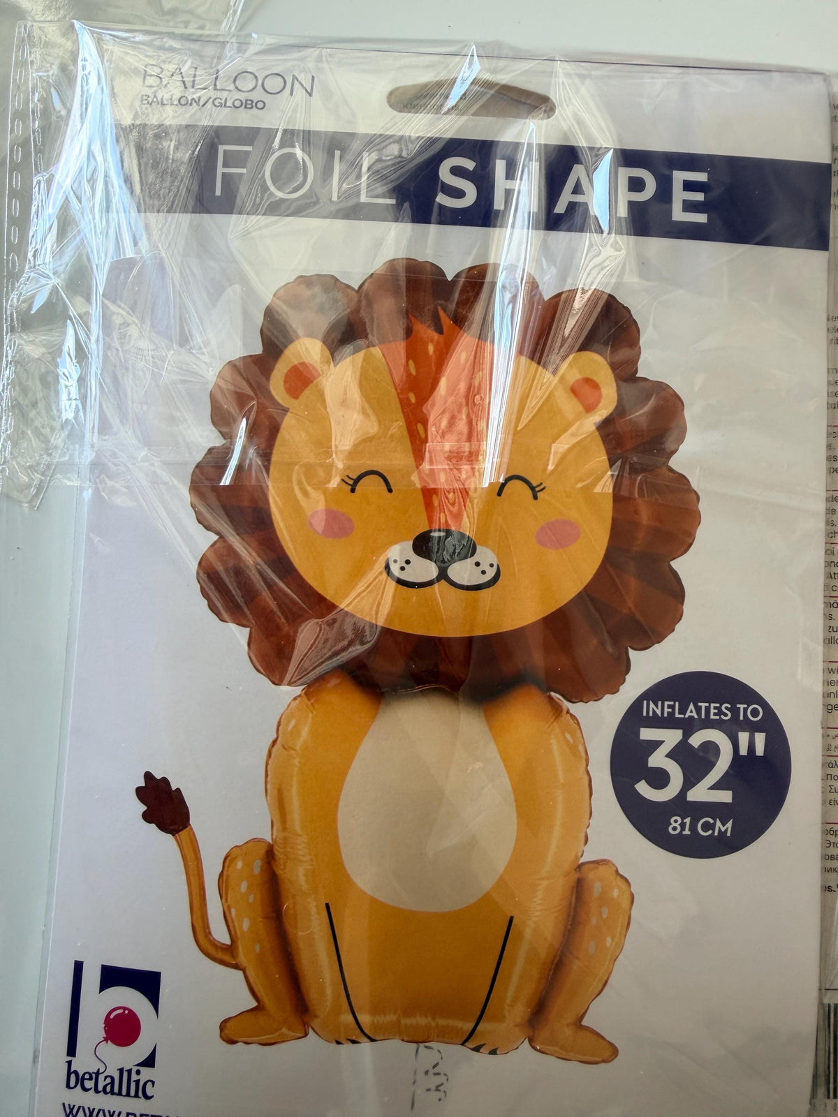 Seated lion foil balloon in retail packaging labeled 32 inches