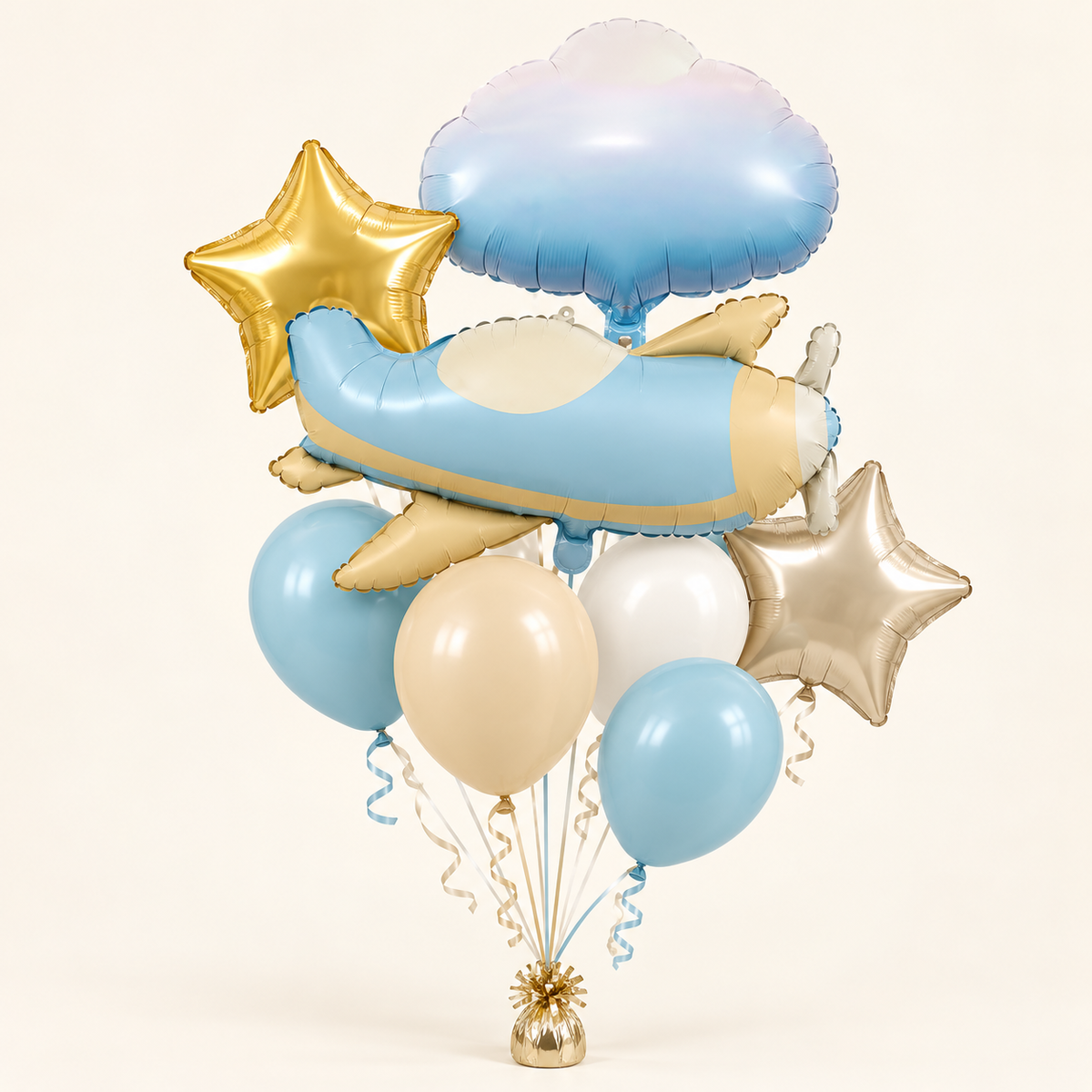Pastel blue airplane balloon bouquet with a gradient cloud, gold and champagne stars, and four blue cream and white latex balloons