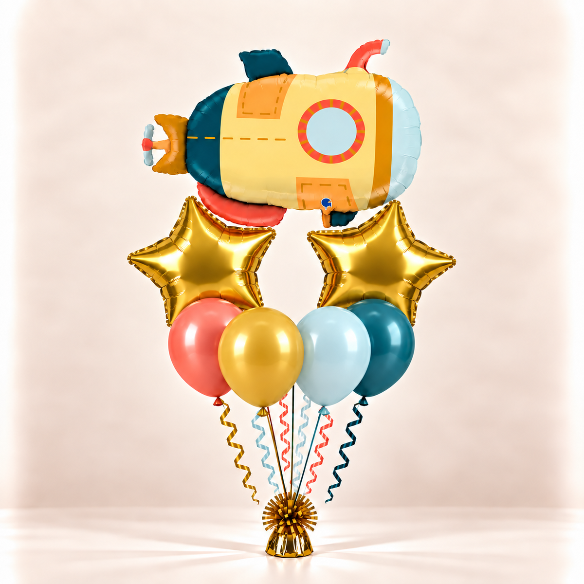 Yellow submarine balloon bouquet with gold stars and coral, gold, light blue, and teal balloons